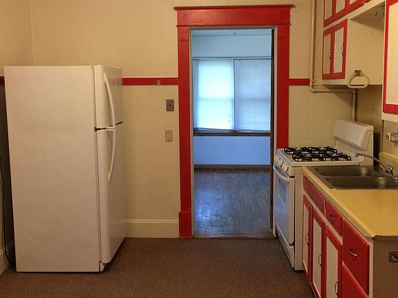 Looking from the kitchen into the bedroom. New refrigerator.