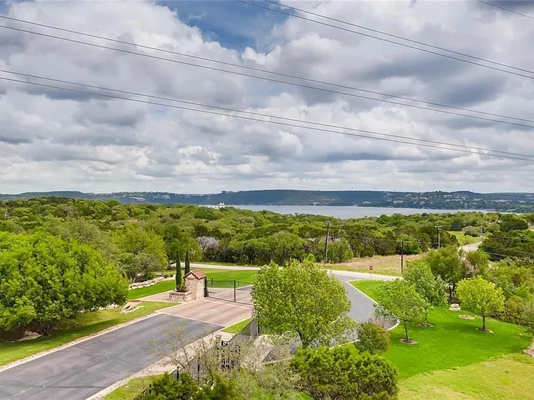 Gated community entrance with a private automated electric gate for added security.