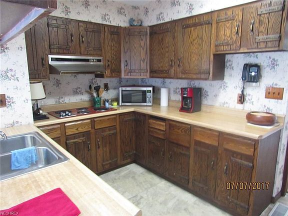 Bright, eat-in  kitchen w/newer vinyl floor and plenty of counter space and cabinets.