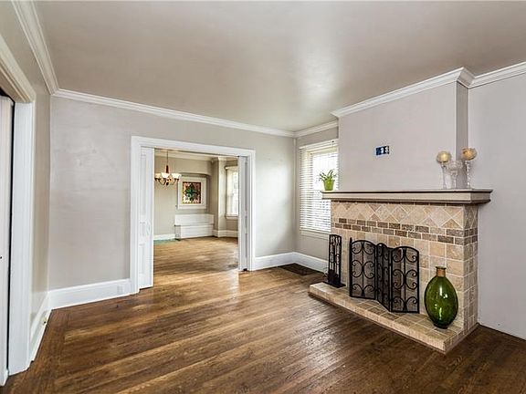 Large living room with hardwood floors and original pocket doors.