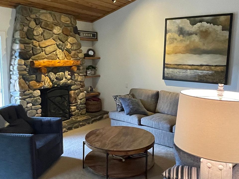 Living room--gas insert river rock fireplace and Top Notch furnishings