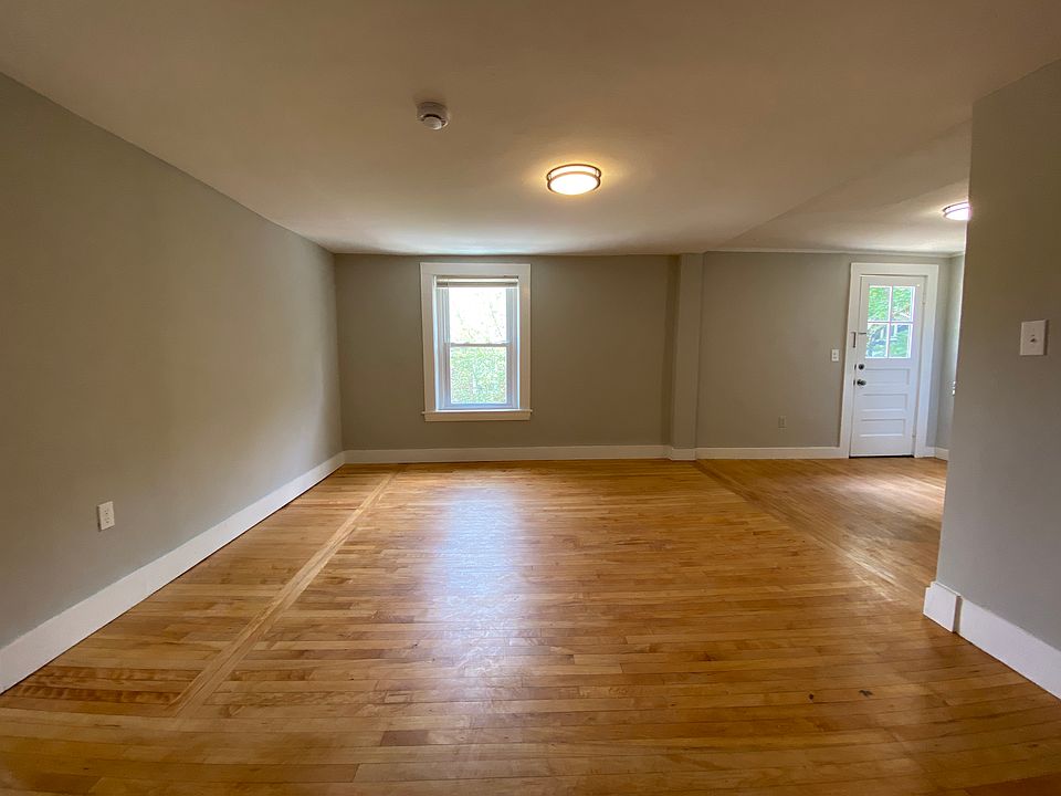 Open floor plan - living room with overhead lighting and hardwood floors