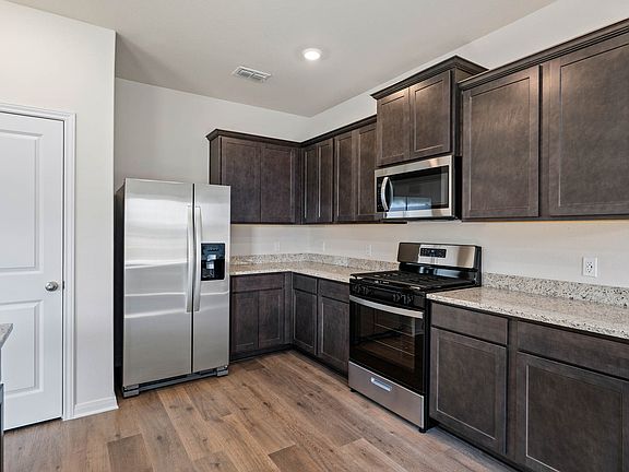 The kitchen has sprawling granite countertops.