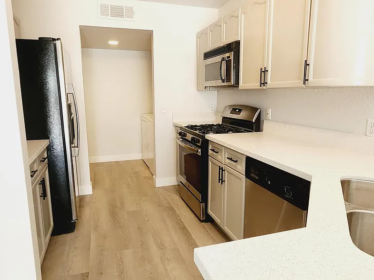 kitchen with quartz countertops, and stainless steel appliances.