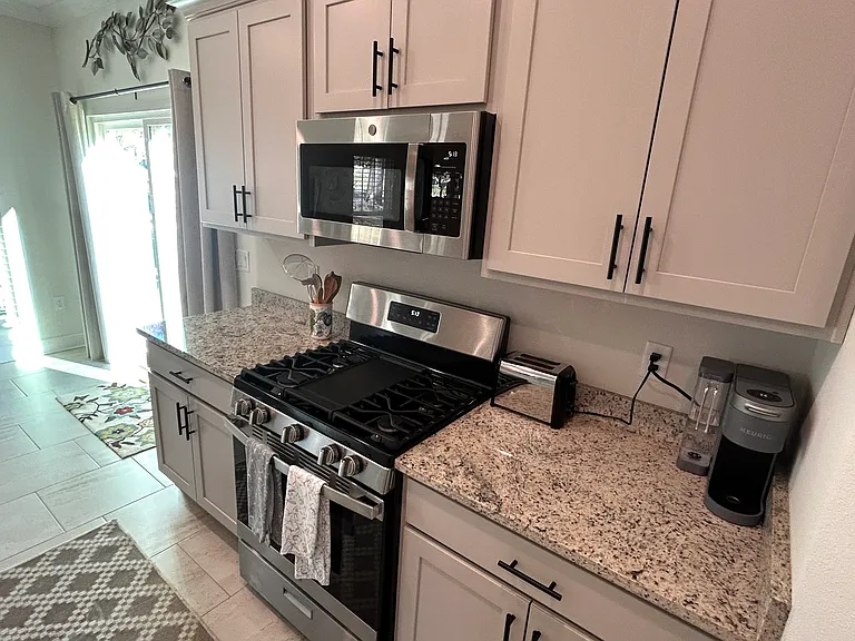 Well equipped kitchen with gas stove and large pantry to the right