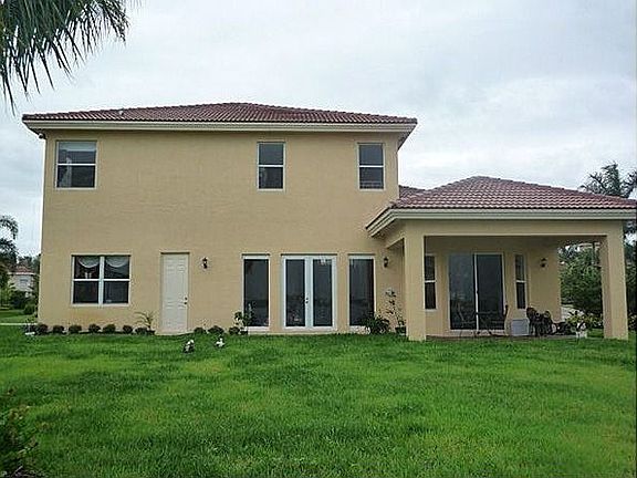 Rear Of The Home With Security Cameras And Lights