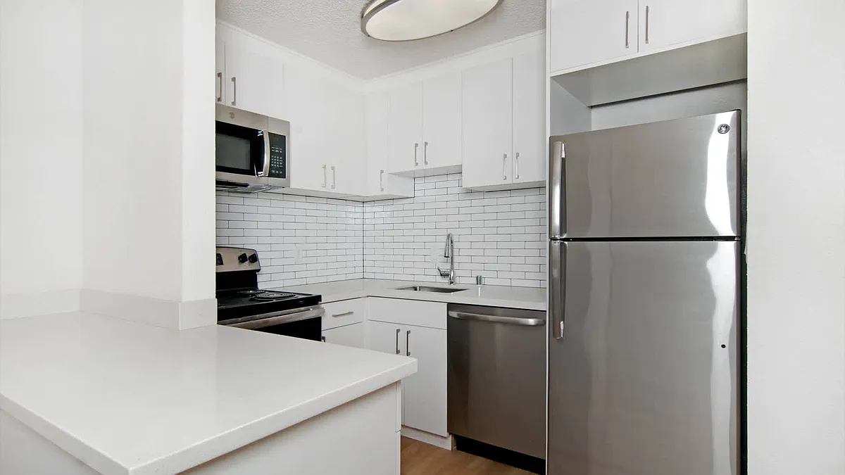 Kitchen with Quartz Countertops and Stainless Steel Appliances - The Terraces