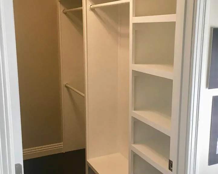 Bedroom #2's walk-in closet (custom-built shelving on both sides)