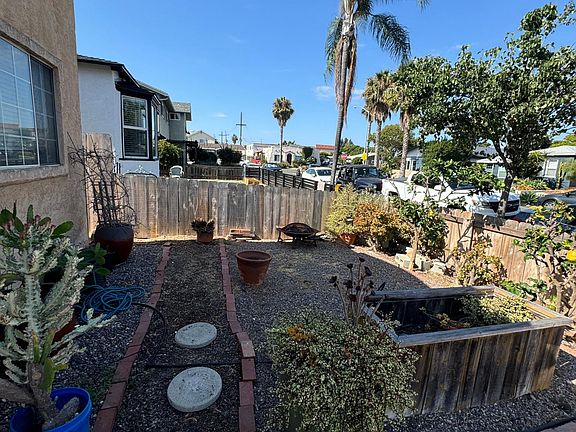 Front yard - Low maintenance and front of property is fenced. Front yard also has two citrus trees.