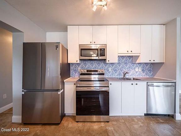 Direct view of the kitchen. This is before we painted a terracotta accent wall to the left of the fridge.