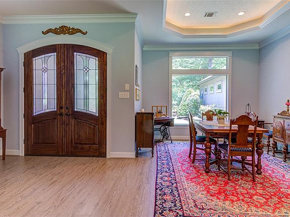 Solid wood and stained glass added touch to the entrance, extra ceiling treatments in every room. Extra crown molding is illuminated by the LED lighting.