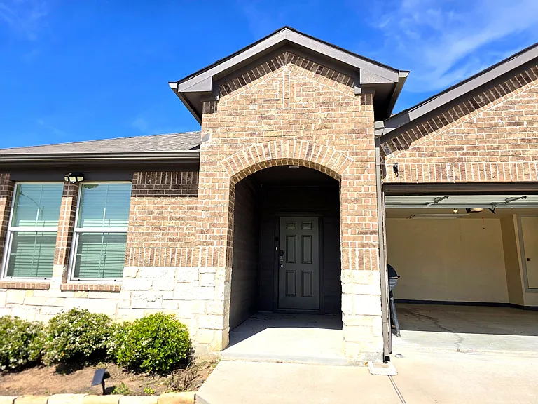Wide driveway and 2-car garage provide plenty of parking space.