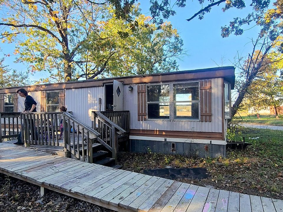 Front of 2 bed one bath mobile home. Showing open spaces around and plenty of private parking.