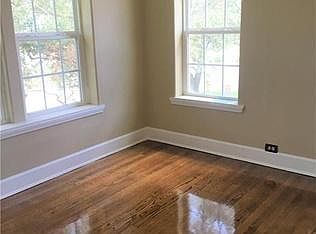 Bedroom with new windows and refinished floors.