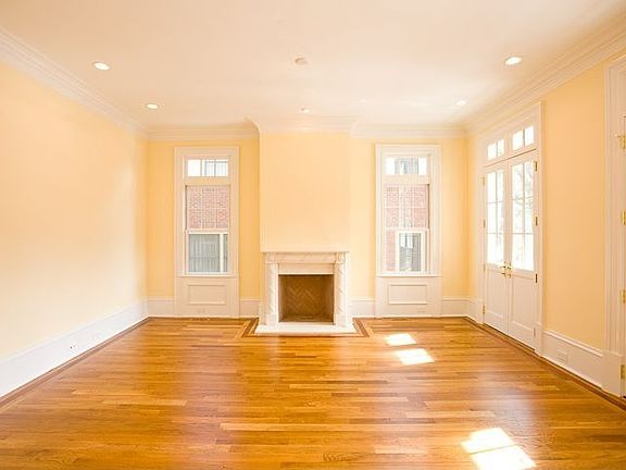 FORMAL LIVING ROOM ANCHORED BY FIEPLACE WITH HANDSOME STONE MANTLE