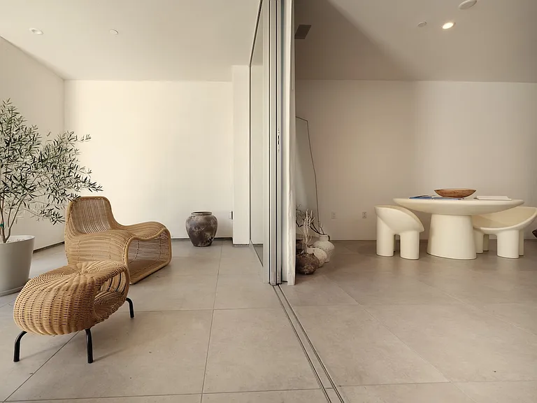 Flexible Indoor-Outdoor Living with Sliding Glass Partitions _ Designed for versatility, this space features floor-to-ceiling sliding glass doors that seamlessly transition between indoor and outdoor areas.