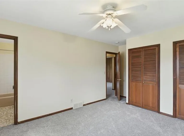 Primary bedroom with dual closets and private bathroom