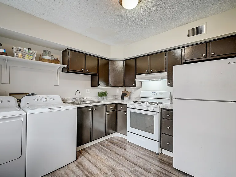 Recently Renovated Townhouse Style Apartments featuring New gray carpet, Neutral paint scheme, Premium hardwood-style flooring, Neutral paint scheme, Upgraded light fixtures, New cabinets, Matching stainless steel appliances, Washer/Dryer, Air conditionin