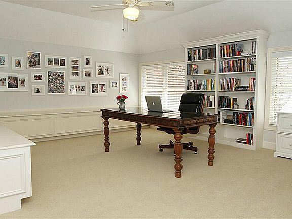 Rare upstairs gameroom with built-in bookshelves and two walls of built-in benches that open for sto