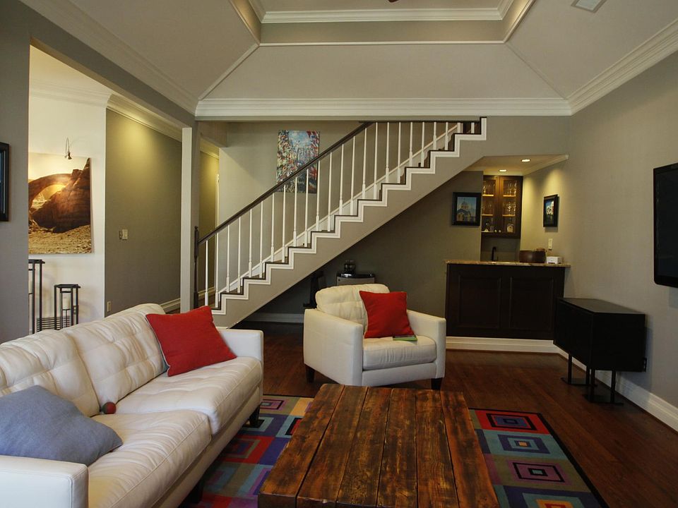 Formal living room includes a wet bar and 12 floor ceiling.