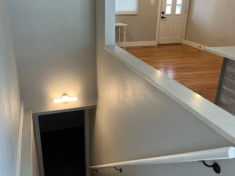 Stairway to basement is next to kitchen (living room is seen in the background).