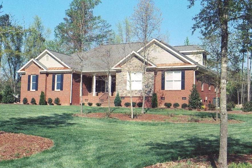 Front exterior of home with perfectly manicured lawn