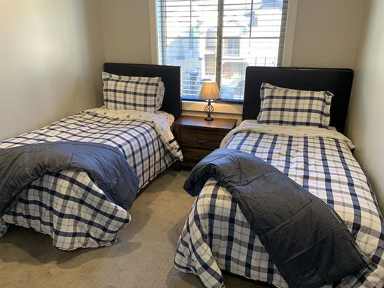Third bedroom features two twin beds desk and walk in closet.