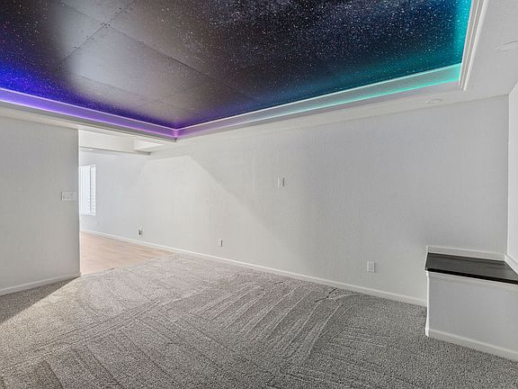 Media room with LED starlight feature and recessed lighting.