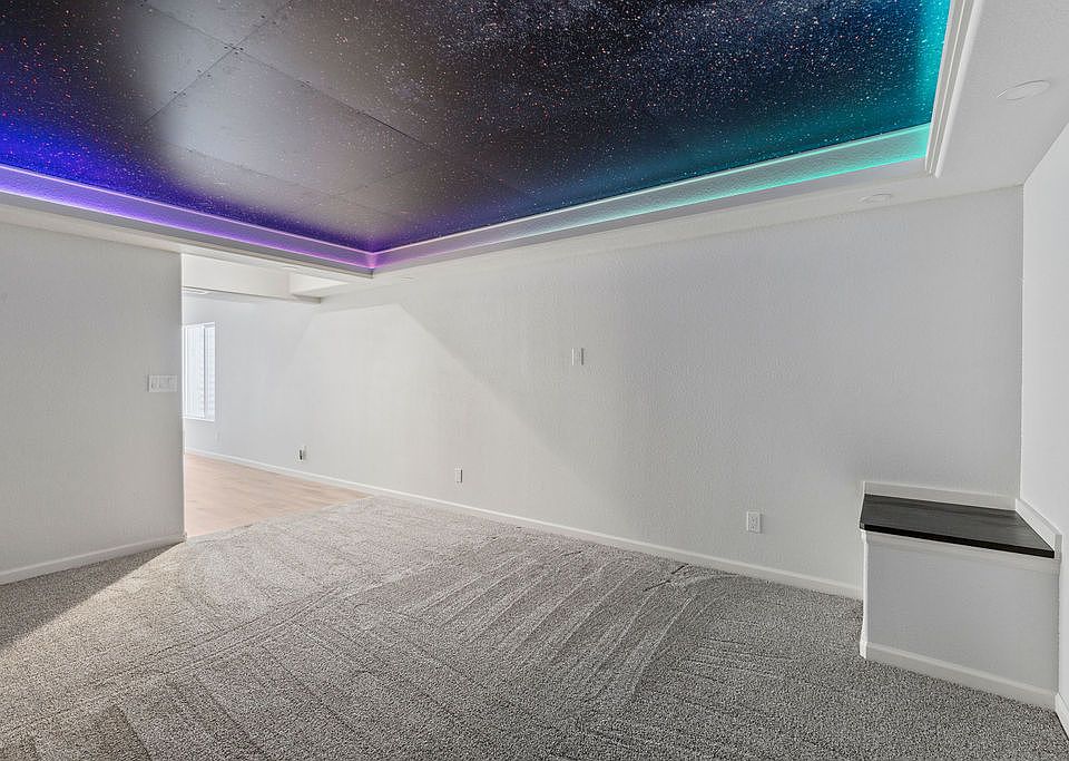 Media room with LED starlight feature and recessed lighting.