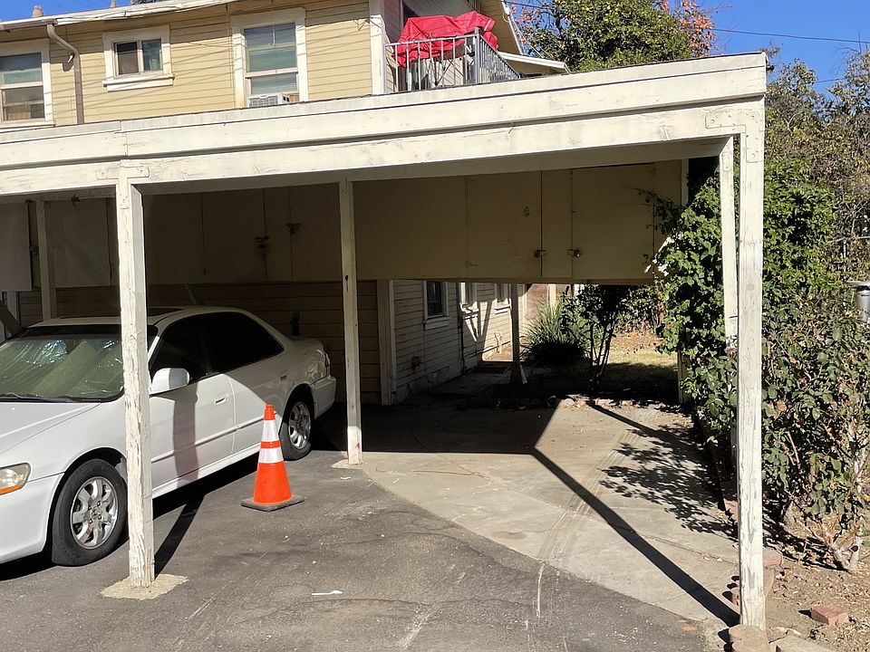 One covered parking space with small storage