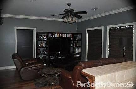 Living Room
						:
						The living room has wood laminate floors and custom woven wood window treatments