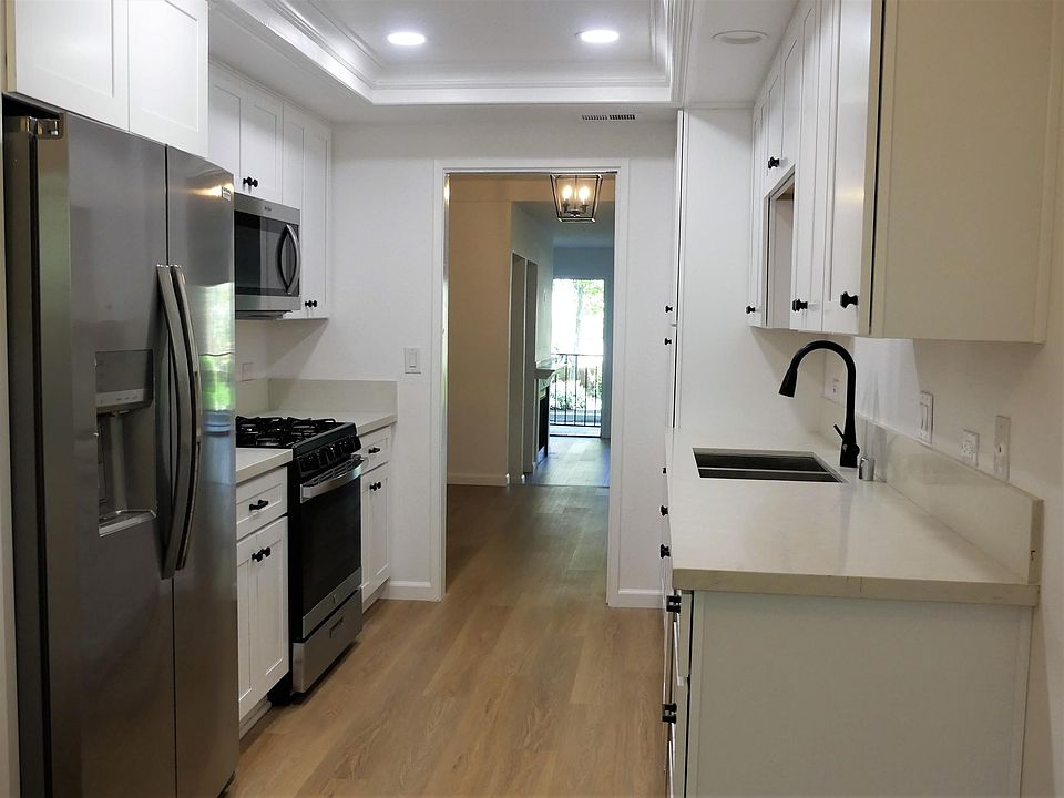 View of kitchen looking toward dining and family rooms and front door.