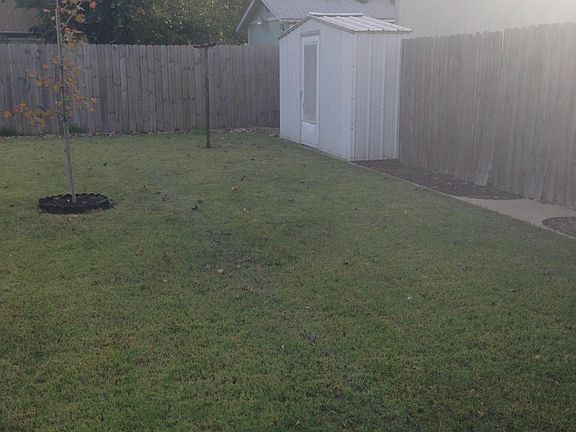 Back yard: 6 ft wood privacy fence on all sides , small shed for storage