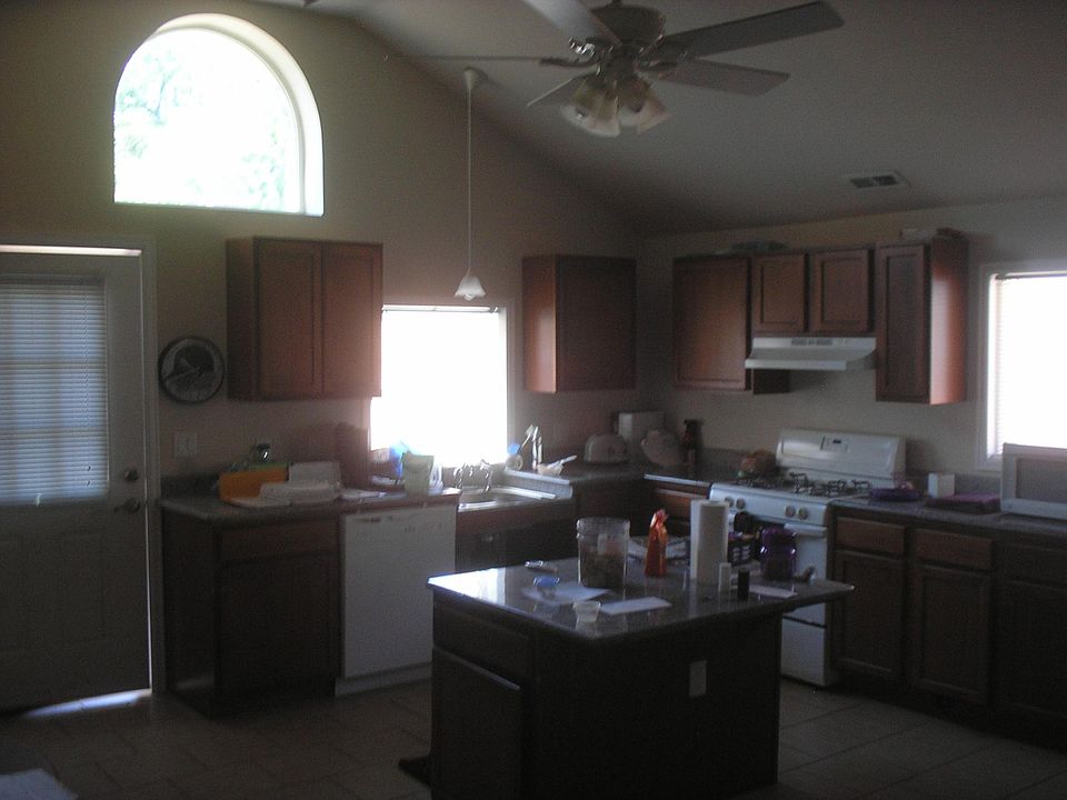 Main entry door to large back yard, full size dishwasher, garbage disposal, gas stove, new maple cabinets, full size refrigerator.