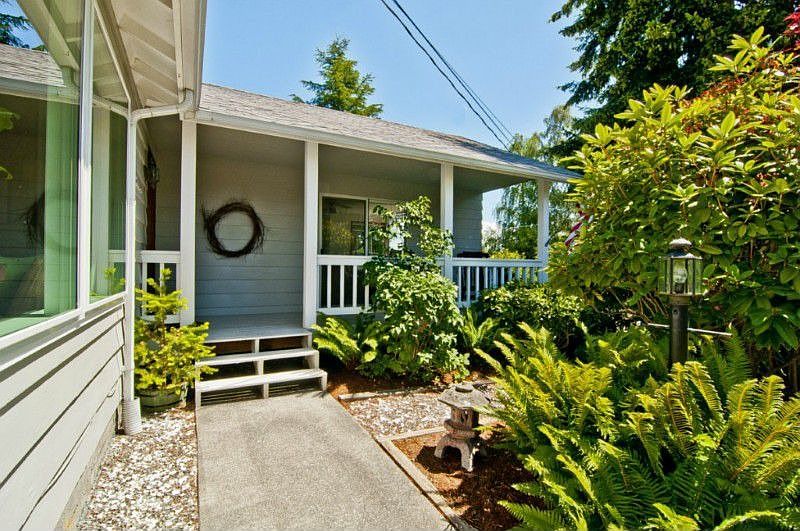 Welcome home. Enter thru a lush landscape to your covered porch.