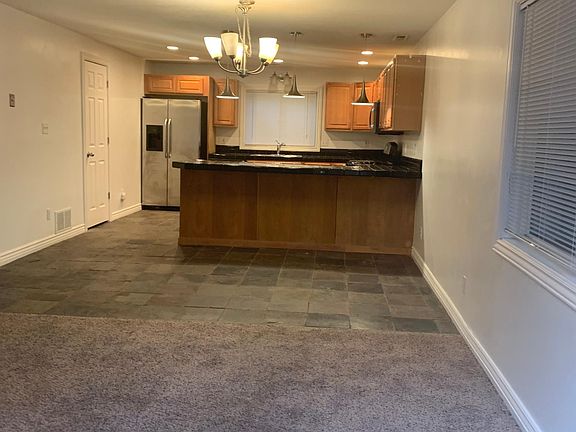 View from front door, the living room & kitchen.