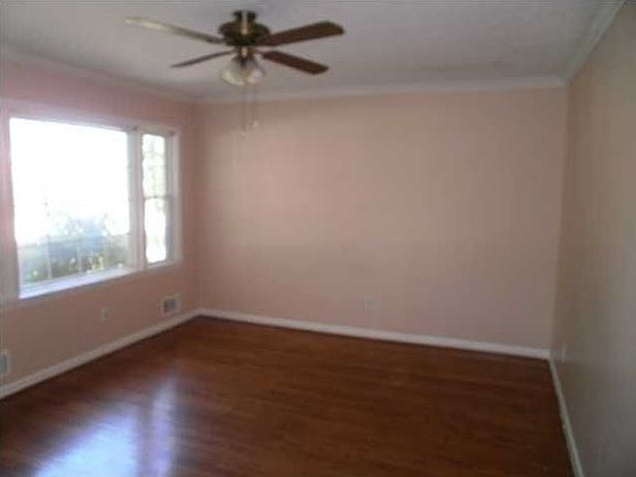 Living Room has crown molding and beautiful hardwood floors