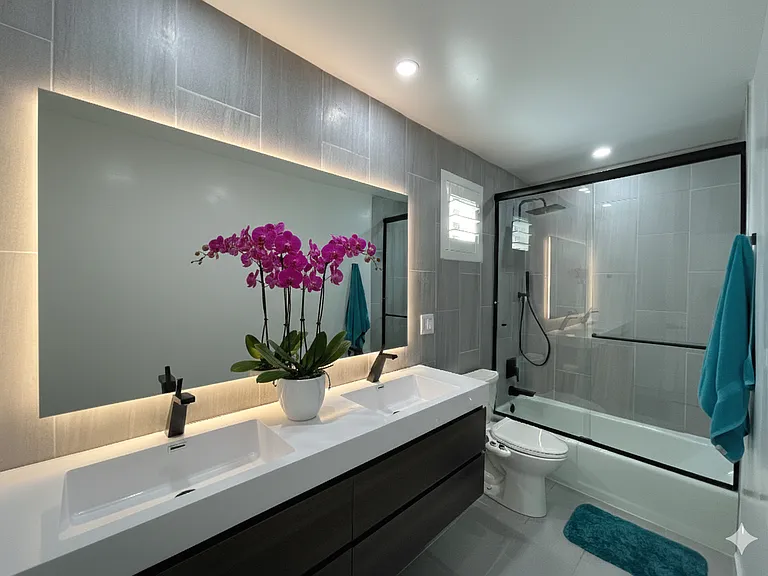 A beautifully updated hall bathroom with modern finishes and thoughtful design serves the secondary bedrooms.