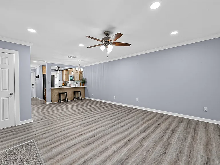 Another view of open space living: kitchen, dining and living room. Extra storage is behind the door on the left. Dining room, kitchen and living areas flow together seamlessly.