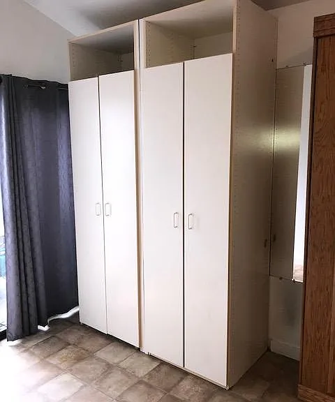 Tall closets with adjustable coat racks and shelves