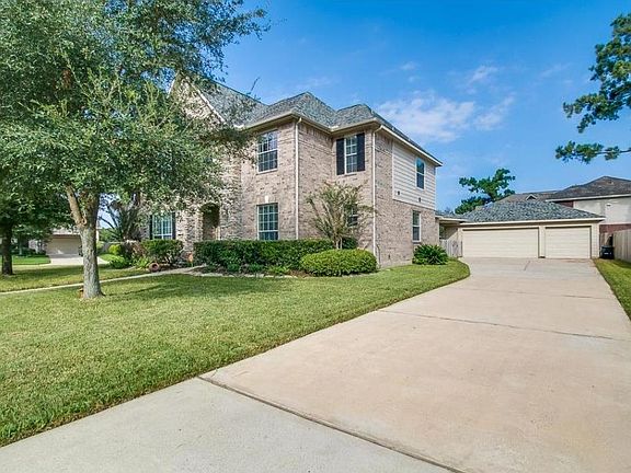 Long driveway with a 3 car garage