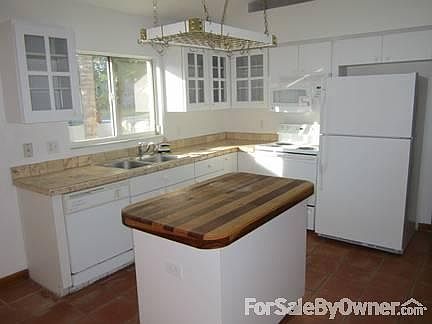 Kitchen
						:
						Island as well as a stone covered breakfast bar.