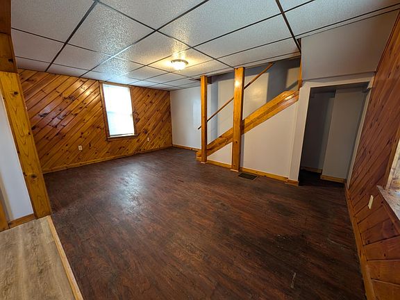 Living room with stairs to 2nd floor and storage nook