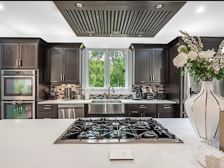 Main House Kitchen with double oven and all cooking appliances. Fully stacked with cooking ustensiles and spices rack.