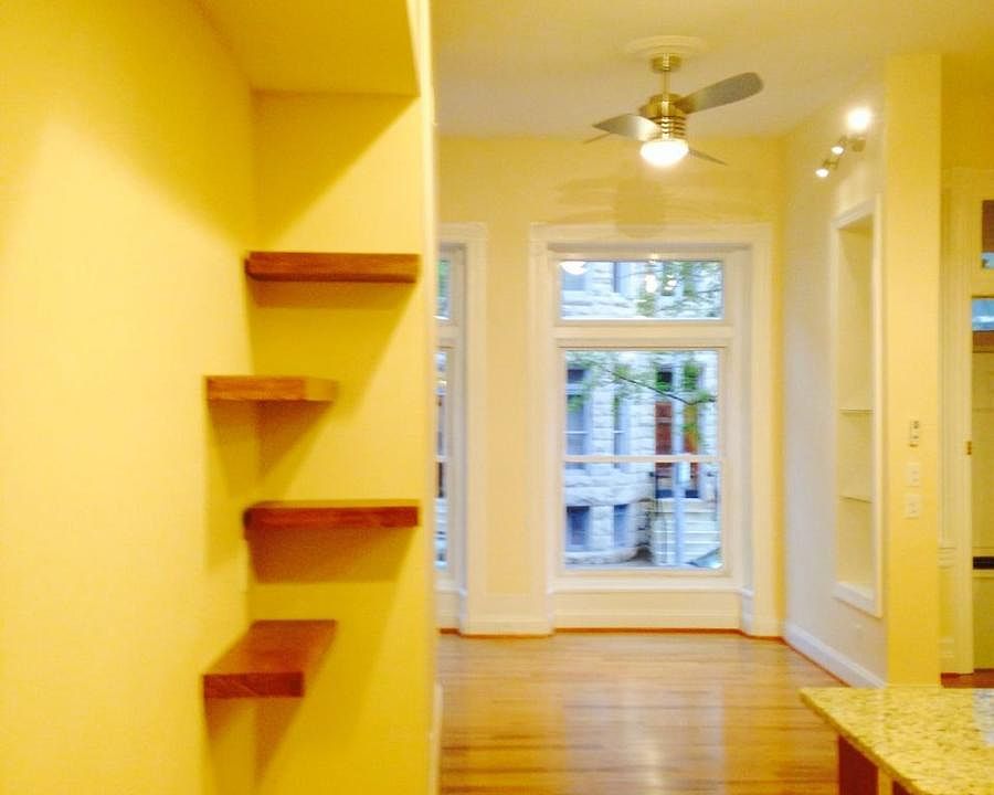 Floating shelves in kitchen facing living room