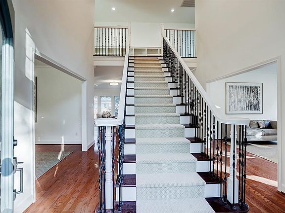 Dramatic 2-story foyer greets you as you enter double leaded glass front doors. Stairway with recent runner, hardwood floors, and recent paint.