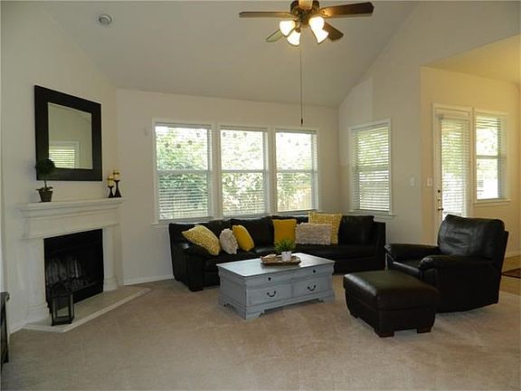 Family room with wood burning fireplace with gas connection if you would like to use gas.  Lots of natural light in this great relaxing room.