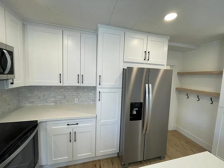 Amazing new kitchen with tons of cabinets and storage, all new- new stainless appliances, marble backsplash, solid quartz counters