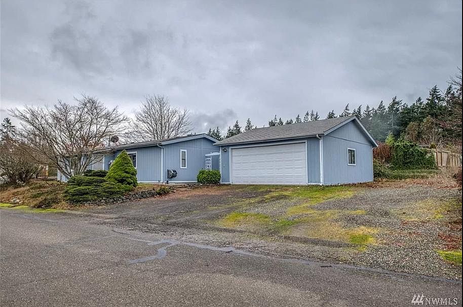 This home has a detached 2- car garage, connected by a covered walkway. There is plenty of extra space to the right side of the garage, in case you would like to park a few extra cars.