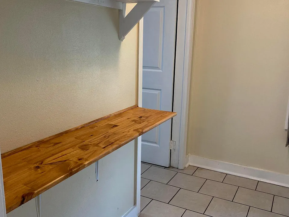 Kitchen has butcher block counter bar